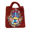 Bolsa tejida y bordada a mano con dijes y parche de Hamsa